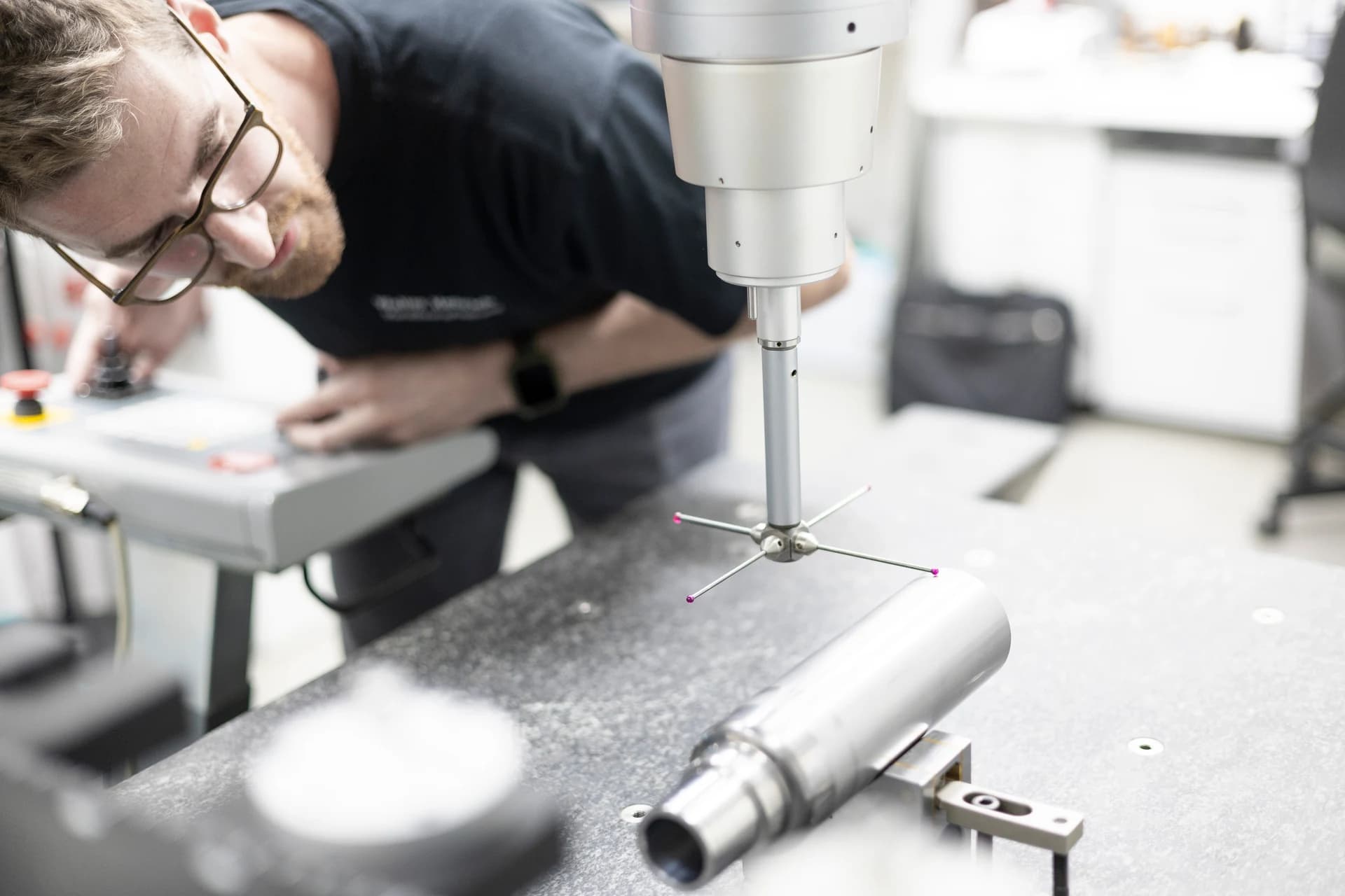 Walter Henrich employee measuring a tube component with a coordinate measuring machine
